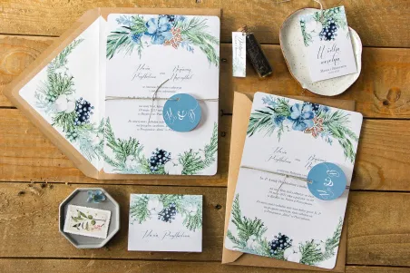 Winterliche Hochzeitseinladungen mit Motiv aus Baumwolle, Lebkuchen und blaugrünen Zweigen