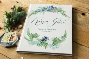 Hochzeitsgästebuch mit Baumwolle, Lebkuchen und blaugrünen Zweigen
