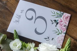 Hochzeitstischnummern in grau. Zum Thema eine Komposition aus weißen und pastellfarbenen Rosen