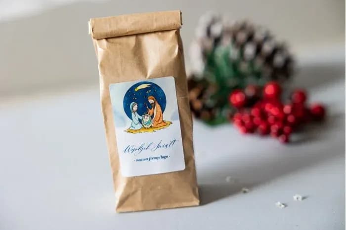 Tea in a kraft bag with a label depicting the nativity scene of Jesus on a blue background