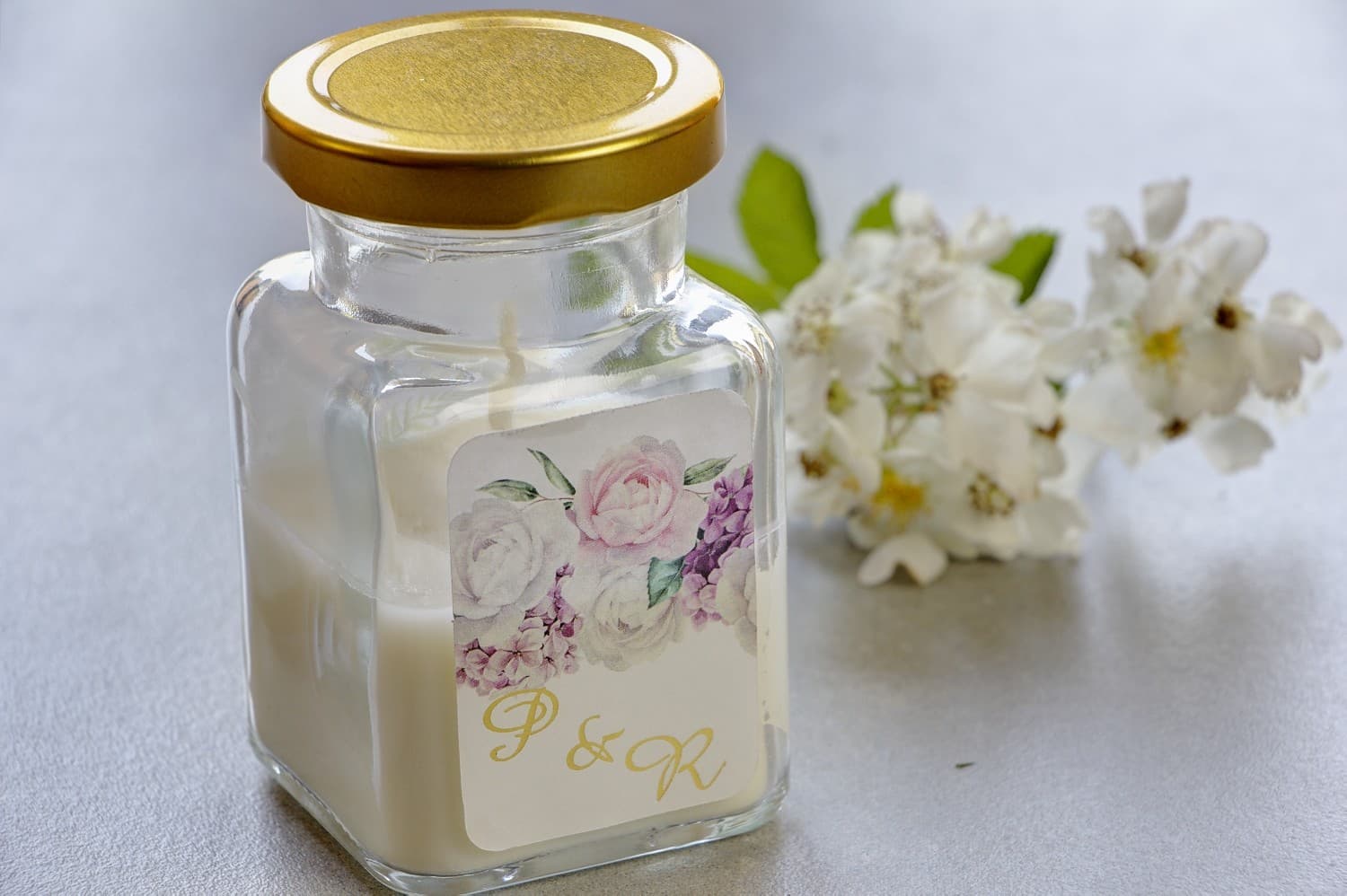 Candela di soia con peonie e doratura per ospiti Candele - nuovi ringraziamenti e regali per ospiti nuziali, matrimoniali. Doratura sull'etichetta e grafica con peonie