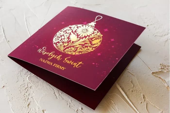 Elegant corporate Christmas card with intense burgundy background and gold foil accents.