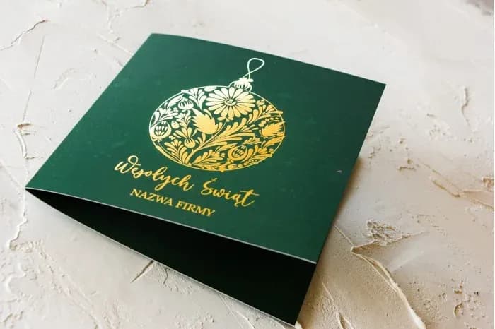 Luxury Christmas card with a dark green background and gold foiled ornaments.