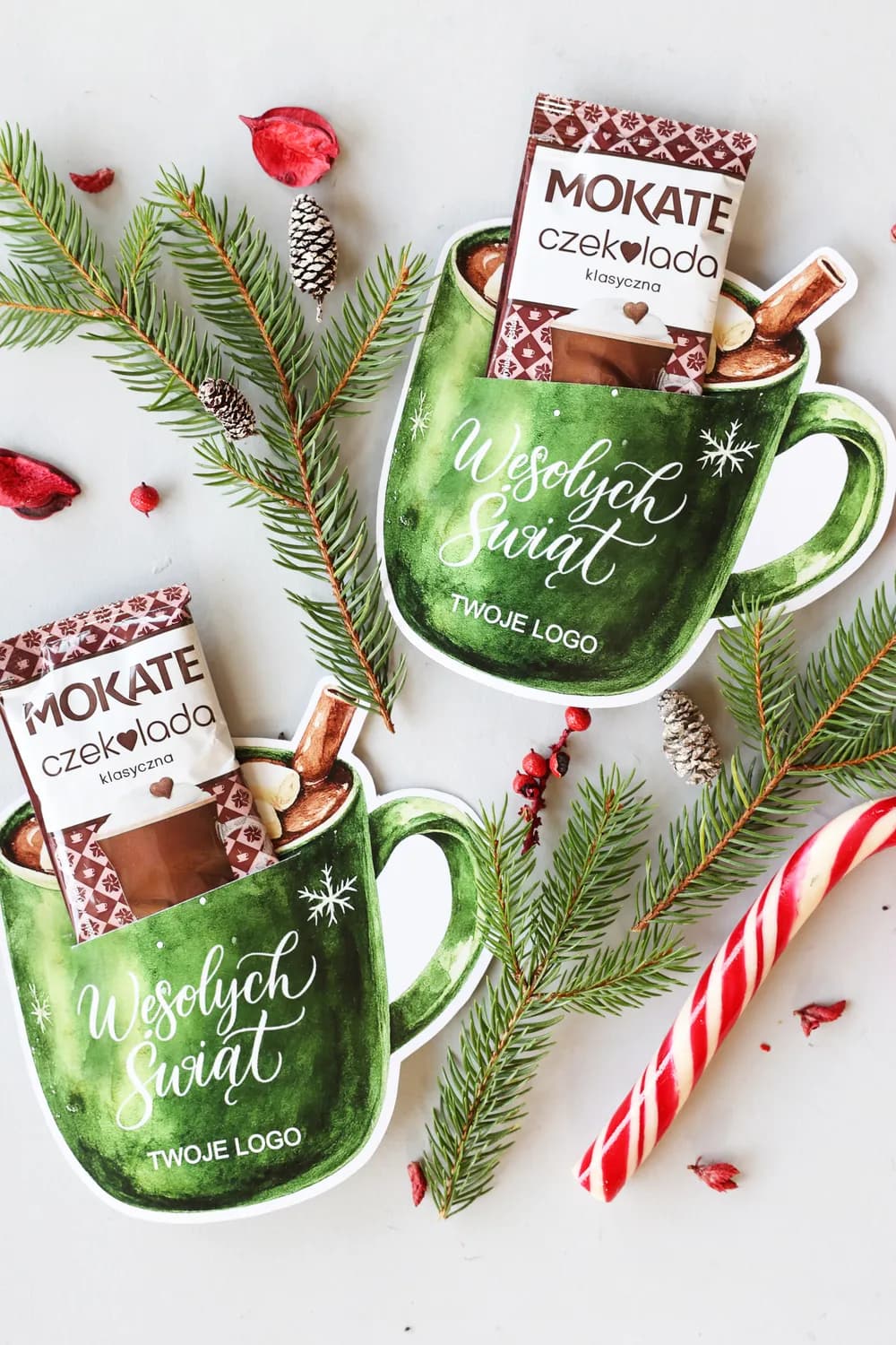 Composition featuring personalized CZK3 chocolate, fir branches, and a candy cane, presenting a sweet thank you gesture.