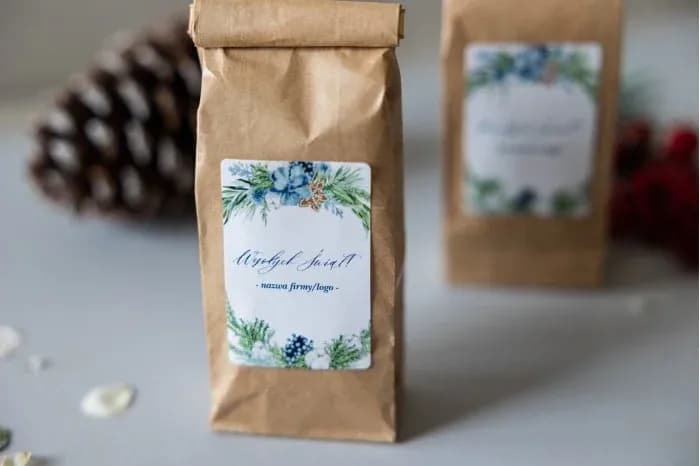 Aromatic tea in a kraft bag with a label decorated with green branches and blue berries