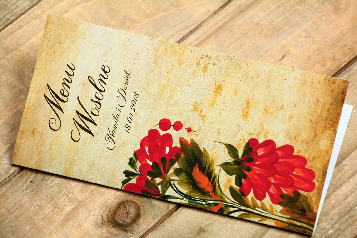 Ludowe Menu Weselne z folklorystyczną kwiatową grafiką.
