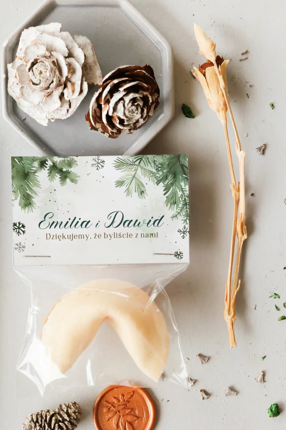 Details of a rustic greenery fortune cookie wrapped in transparent foil