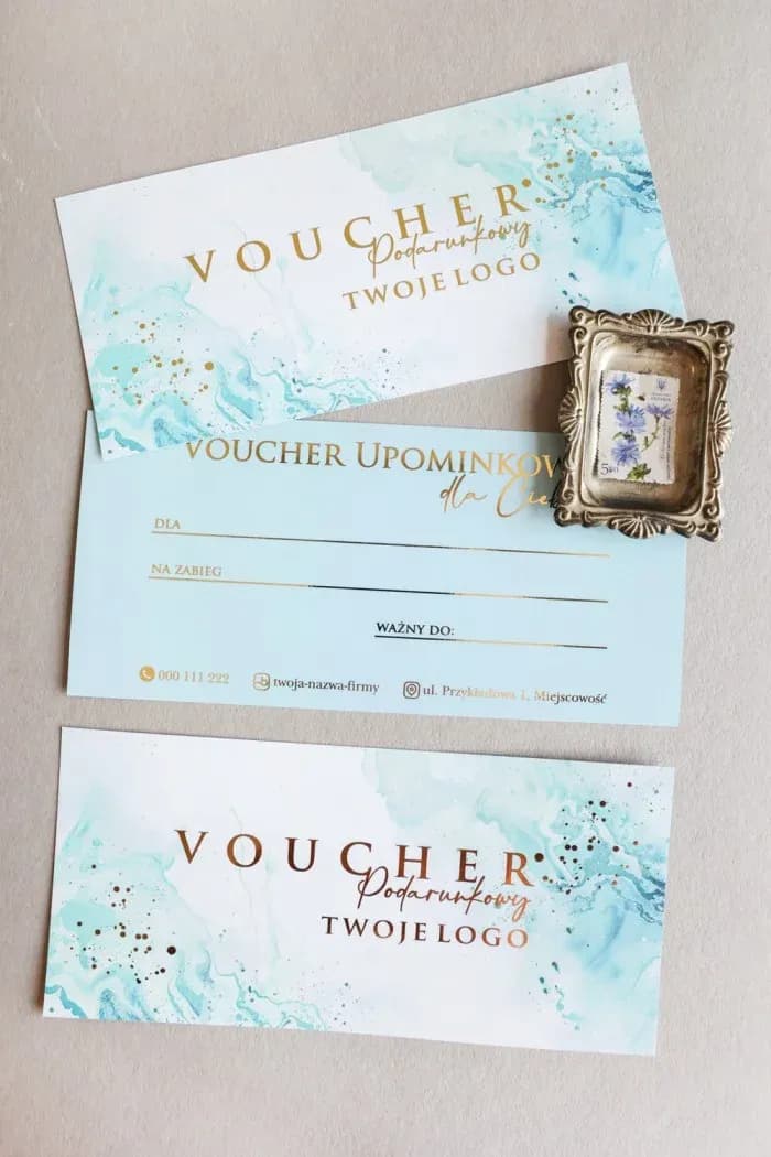 Subtle voucher with marble pattern and elegant gold foiling on a light background.