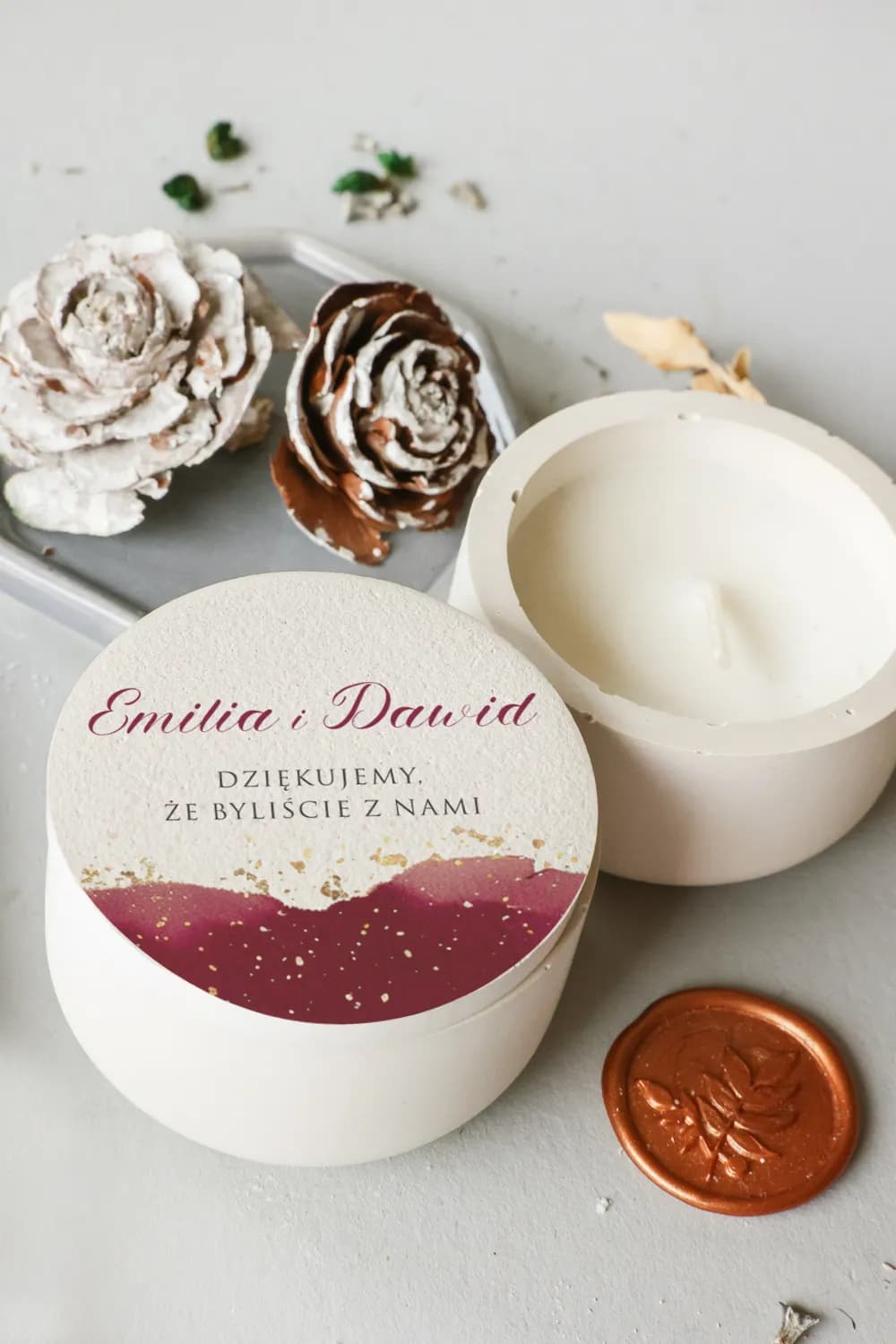 Personalized soy candle wedding favour with a burgundy and gold graphic lid design